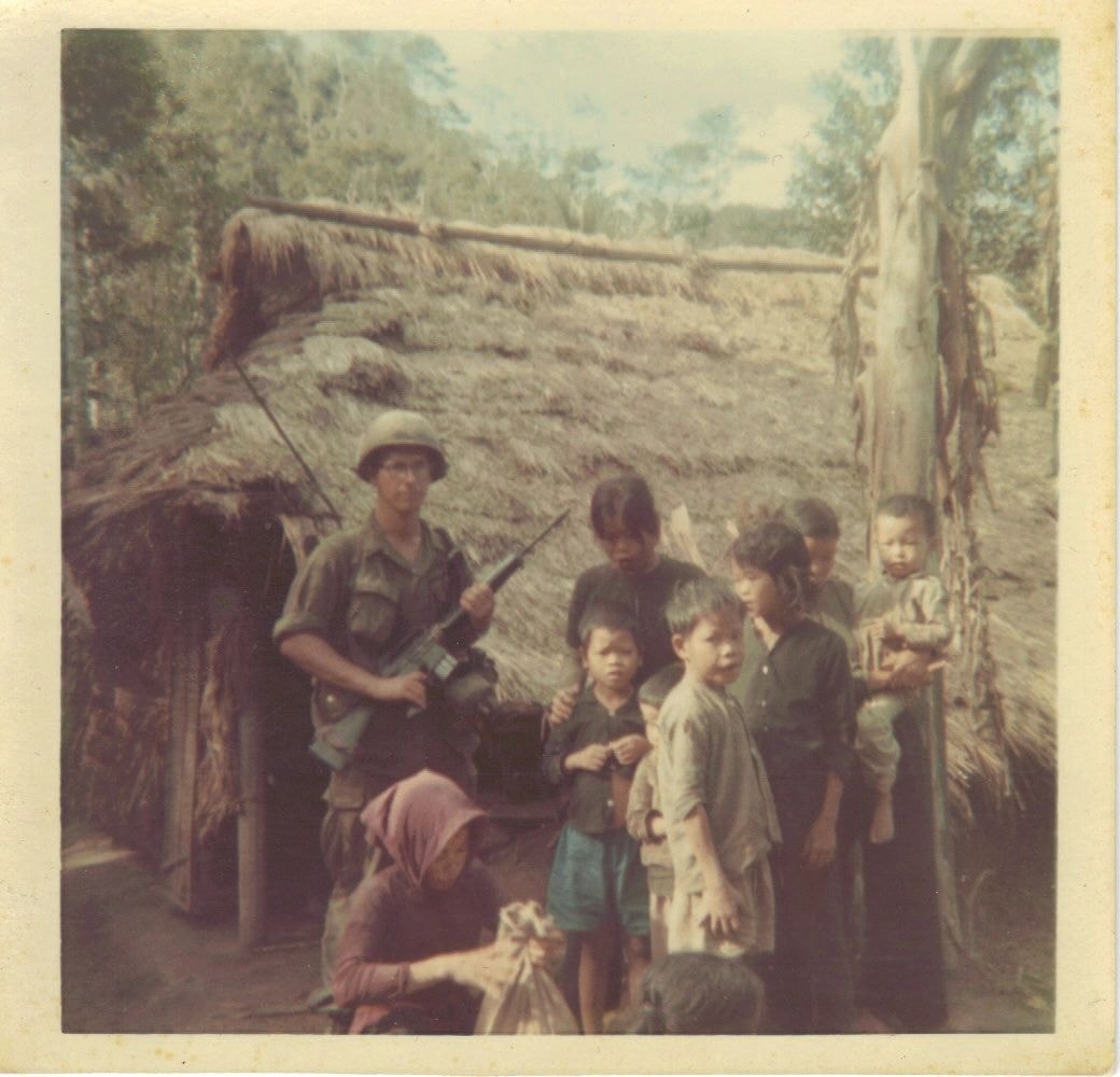 Vietnam soldier with village children