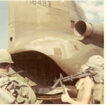 Soldiers riding inside a Chinook helicopter